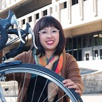 Annie Pho and her bicycle in front of the Daley Library