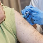 Man recieves flu shot in arm