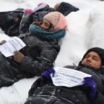 students laying in the snow