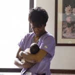 nurse holding baby in nursery room