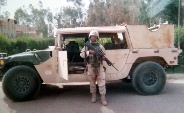 Maria Mckiever in front of a Humvee