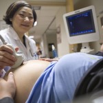 sonographer giving an ultrasound to a pregnant woman