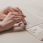 female hands typing on a keyboard