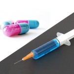 split image of medication capsules and a syringe filled with liquid