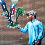 Mural of an African American man holding up a map that has turned 3-dimensional