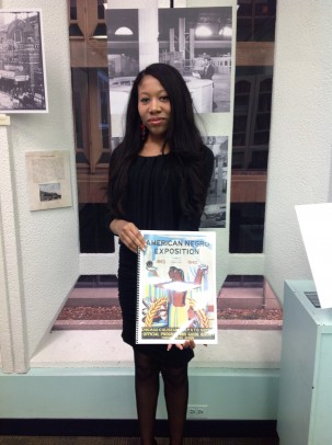 Jacqueline Y. Smith holding a book on the American Negro Exposition