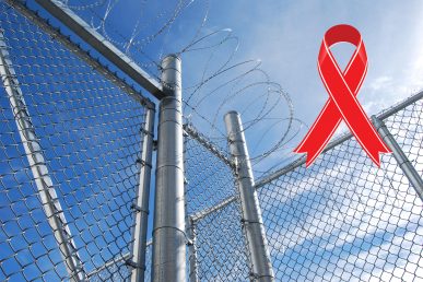 barbed wire fence with a red ribbon representing HIV/AIDS awareness