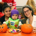 Dr. Mary Lou Schmidt decorates pumpkins with her patient