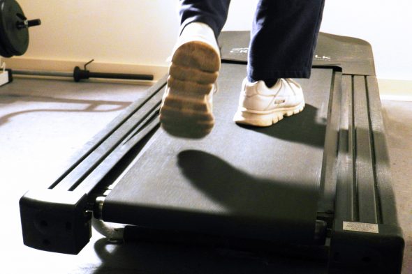 feet of person walking on a treadmill