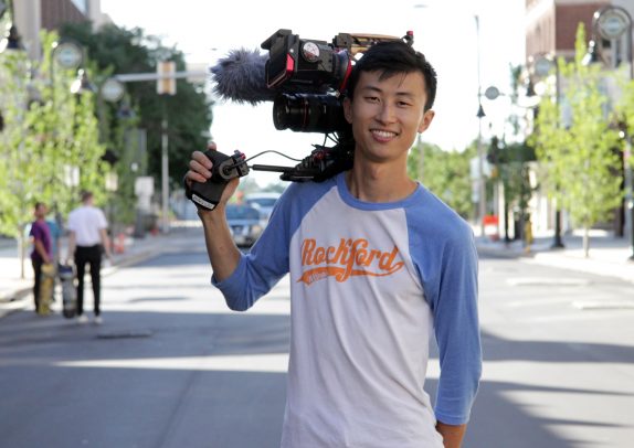 Bing Liu holding film camera on “Minding the Gap" set.