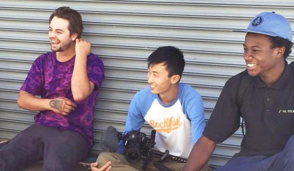 Bing Liu sitting with actors on the “Minding the Gap" set.