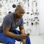 Man texting in workshop