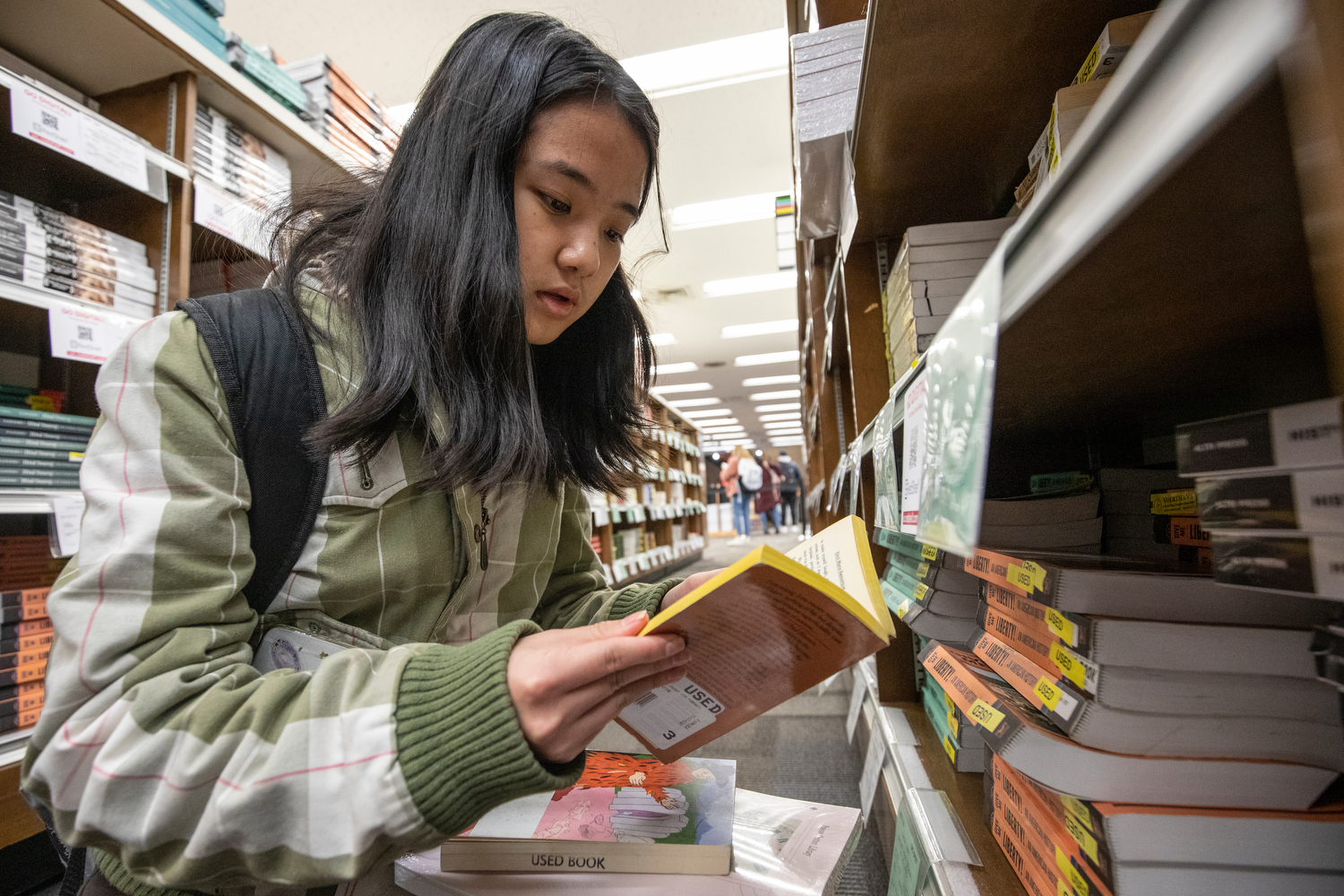 Transfer student Cathy Ouyang (EDU '22) looks at books for her history class at the bookstore in Student Center East during her first day on campus.