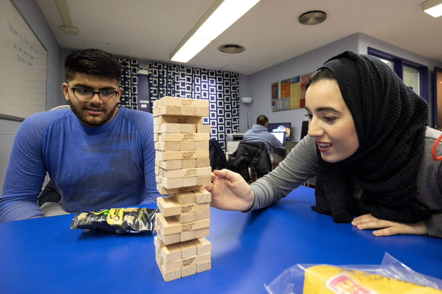 Tamara Jumah (LAS '22), right, plays Jenga with Zakee Jabbar (LAS '20) during AHS Academic Support and Achievement Program's open house in the Physical Education Building.