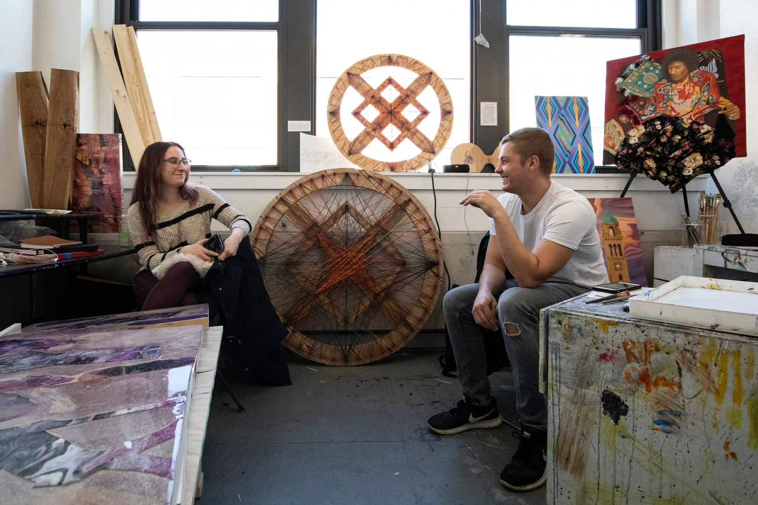 Alicia Meyer (CADA '20) and Josiah David (CADA '20) chat in the BFA thesis studio in Art and Design Hall as they wait for one-on-one studio visits from professors during their thesis course.