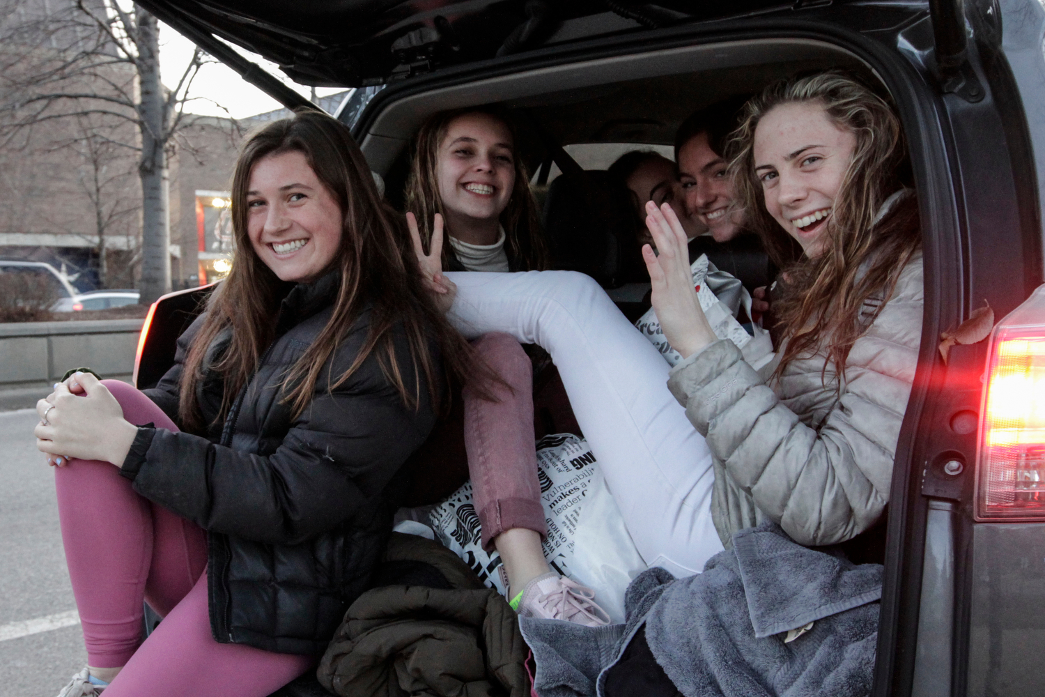 Students pack the back of an SUV after class on Roosevelt Road near the Flames Athletic Center.