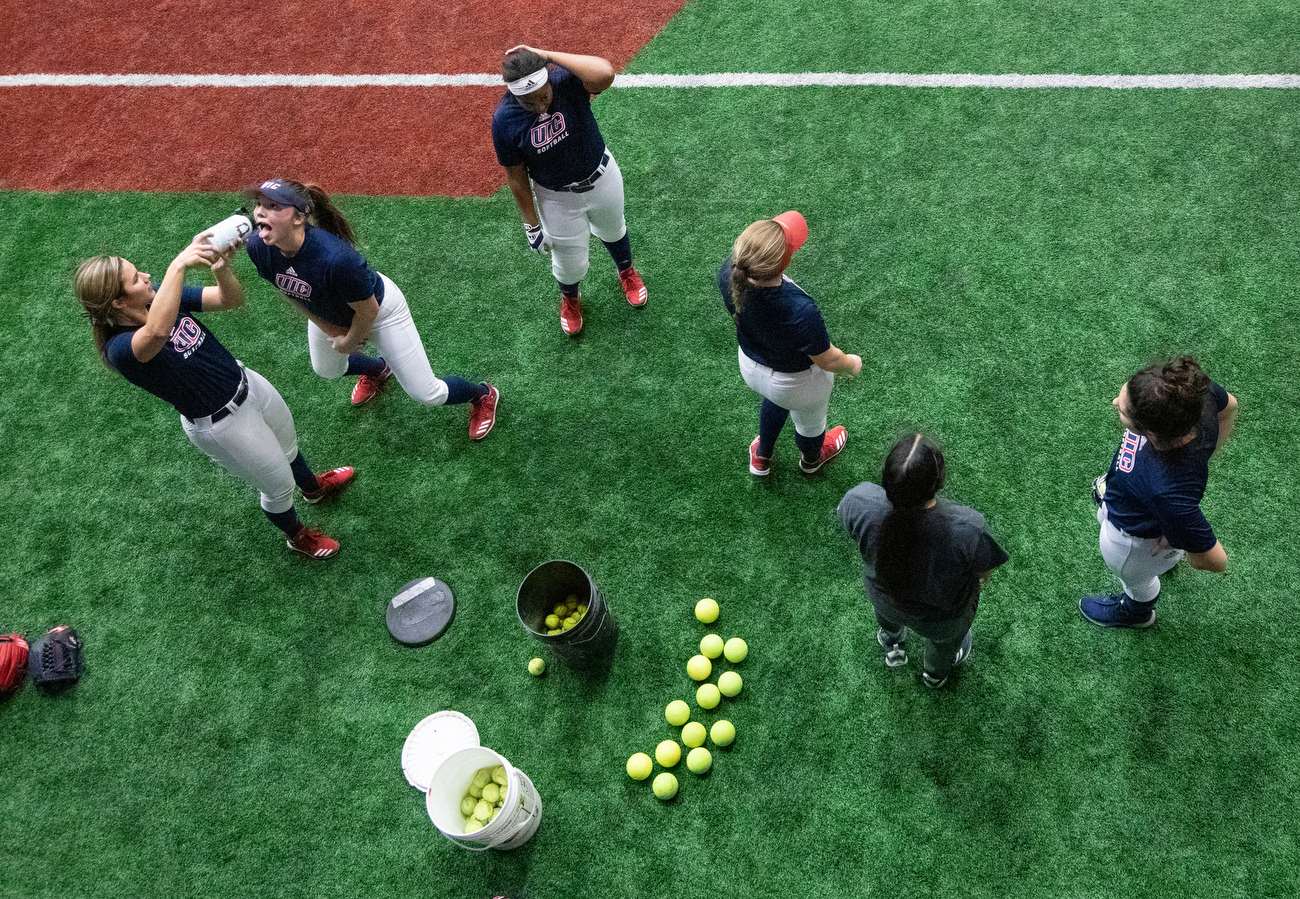 Softball outfielders take a water break during an evening practice on Thursday in the Flames Athletic Center. Spring sport teams started their official practices this week.