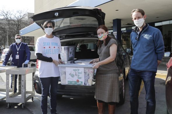 Chicago's First Lady Amy Eshleman, left, helps Rebecca Rugg, dean of the College of Architecture Design and the Arts, and Chris Plevin of the Chicago Shakespeare Theater deliver 5,000 fabric face masks to the University of Illinois Hospital April 3.