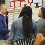 UIC College of Education Assistant Professor of Science Education Daniel Morales-Doyle speaks with public school teachers and alumna at a UIC gathering focusing on urban science education initiatives.