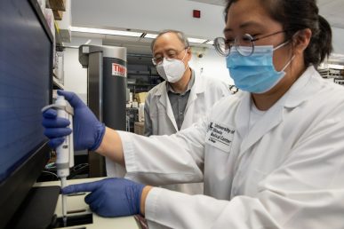 Dr. Xiaoping Du oversees PhD student Yaping Zhanga enter a sample in an aggregometer in his lab