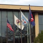 American flag, Illinois state flag, Chicago flag, and UIC flag flying outside Student Center East