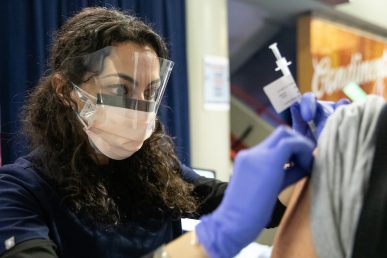 Dentistry student Inesa Tshagharyan administers COVID-19 vaccinations at the Credit Union 1 Arena on Monday, Feb. 1, 2021, at the University of Illinois Chicago. (Joshua Clark/University of Illinois Chicago)