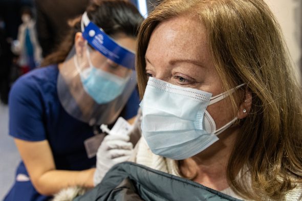 Donna Buchanan receives the COVID-19 vaccine in the Credit Union 1 Arena on Monday, Feb. 1, 2021, at the University of Illinois Chicago. Nursing student Maria Escamilla administers the shot. (Joshua Clark/University of Illinois Chicago)