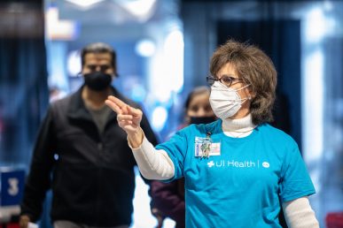 Dentistry Associate Dean Dr. Susan Rowan directs people to vaccinators at Credit Union 1 Arena on Monday, Feb. 1, 2021, at the University of Illinois Chicago. (Joshua Clark/University of Illinois Chicago)