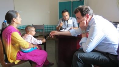 Dr. Damiano Rondelli visits with a young patient. 