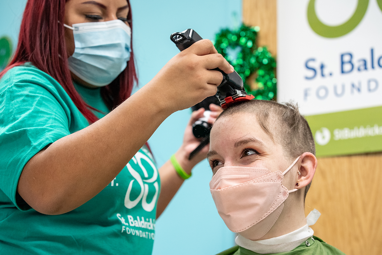 Ashley Roman, a UIC student majoring in mechanical engineering, gets her head shaved during the annual St. Baldrick's fundraiser at the Children's Hospital University of Illinois Feb. 18.