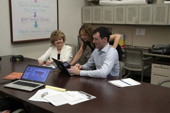 Shelby Cosner, center, works with members of the Center for Urba