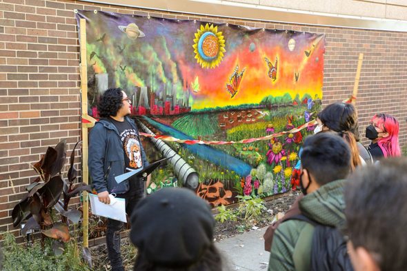 Artist Mario Mena speaks about the class he led which painted the new mural urban pollinators.