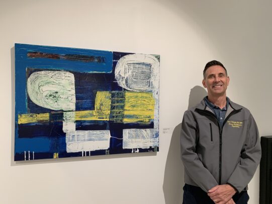 Clinical assistant professor Sean Murphy with his original artwork.
