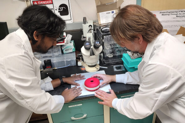 Nitin Jayakumar and Igor Paprotny work on a prototype of their device for detecting airborne virus particles.