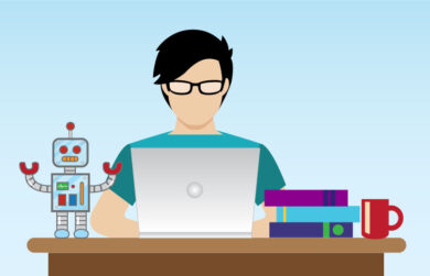 A man with glasses works on a laptop between two piles of books, one with a robot on top and one with a coffee cup on top.