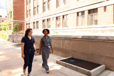 Dr. Sarah Messmer and Dr. Lauren Williams walk UIC campus.