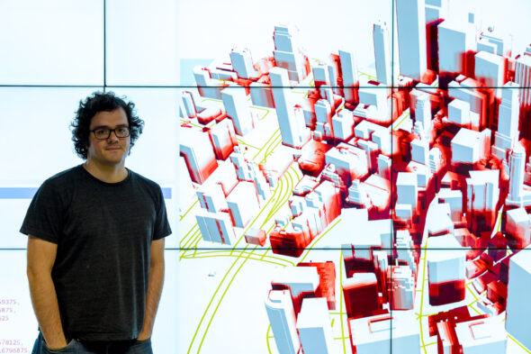 Fabio Miranda is an Assistant Professor at the Department of Computer Science at the University of Illinois Chicago. He is standing in front to a code generated map.
