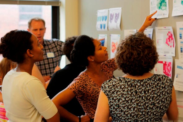 Courtesy of the Children’s Environmental Health Initiative. State health department staff discuss example maps they've created at a GIS training capacity building session led by CEHI.