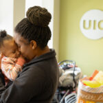Dominique Graham holds her nine-month-old daughter Amiyah at the UIC Community Center in Auburn Gresham. (Photo: Jenny Fontaine/University of Illinois Chicago)