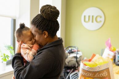 Dominique Graham holds her nine-month-old daughter Amiyah at the UIC Community Center in Auburn Gresham. (Photo: Jenny Fontaine/University of Illinois Chicago)