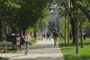 Students walking across campus in the summer.
