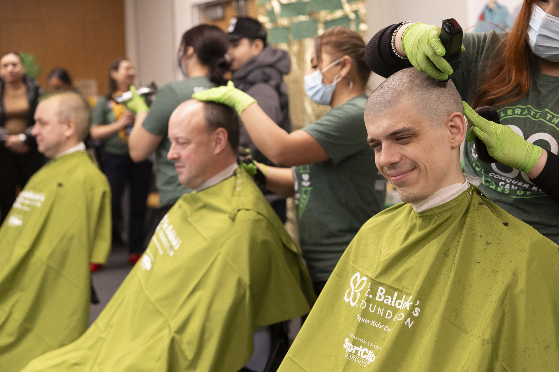 Amid the sounds of trimmers and cheers, thirteen people volunteered to have their heads shaved Feb. 23, 2024, to raise money for St. Baldrick's Foundation to help fund pediatric cancer research. (Jenny Fontaine / UIC)