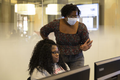 Briana Hanny assists student Ve'Linda Kimble in her efforts. Photography by Jenny Fontaine