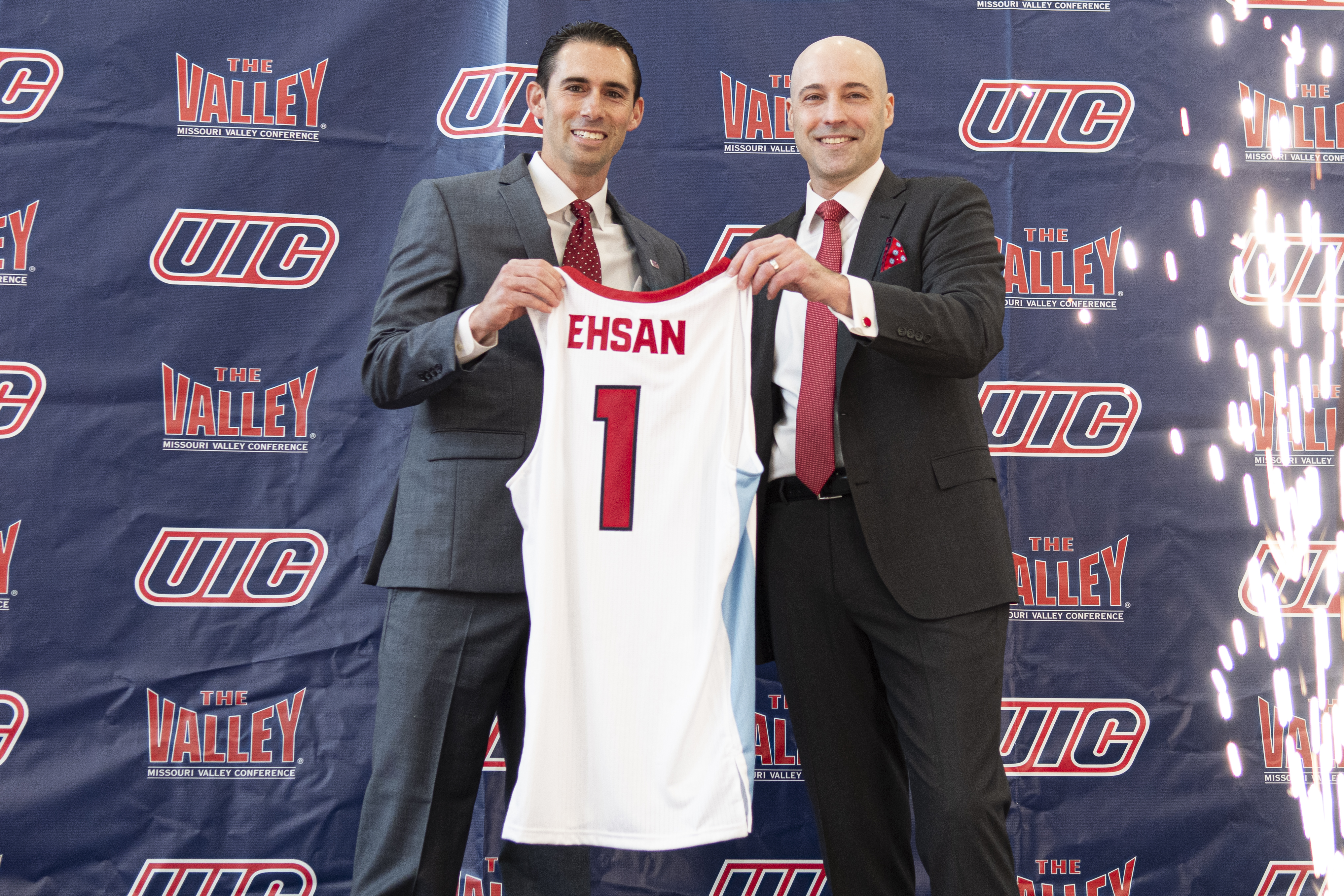 Rob Ehsan, left, and UIC Director of Athletics Michael Lipitz hold up a jersey at the April 1 press conference announcing Ehsan's appointment as the new head coach for UIC men's basketball. (Phil Bergman)