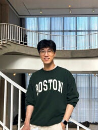 Student smiling in a stair case