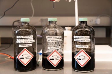 Three glass bottles containing a black liquid.