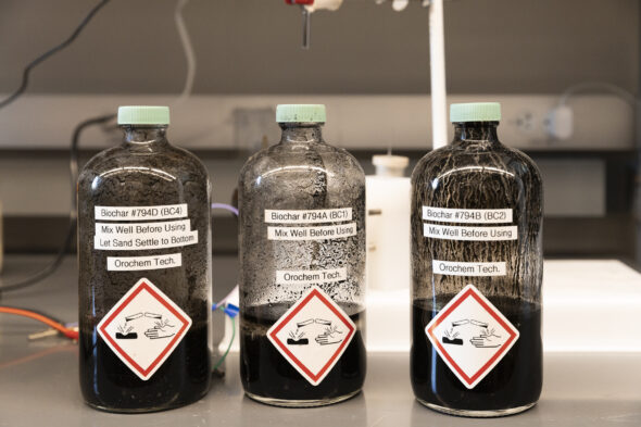 Three glass bottles containing a black liquid.