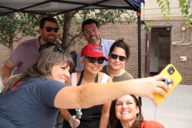 Ice Cream Social 2023. People interacting in the quad. Chancellor Marie Lynn Miranda serving ice cream to students, faculty, and staff. It was a beautiful day in the summer where everyone was socializing and enjoying each others company.