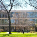 Student walking by Douglas Hall on the east campus on a early spring day. Photo by Jenny Fontaine/UIC