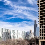 View of the Academic Residential Complex and University Hall with the Chicago skyline in the background. Photo by Jenny Fontaine/UIC